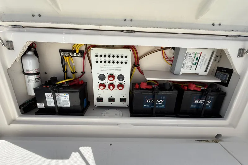 Slide: The Image of Electrical panel and batteries in a 2015 Robalo R305 Walkaround boat. - 25