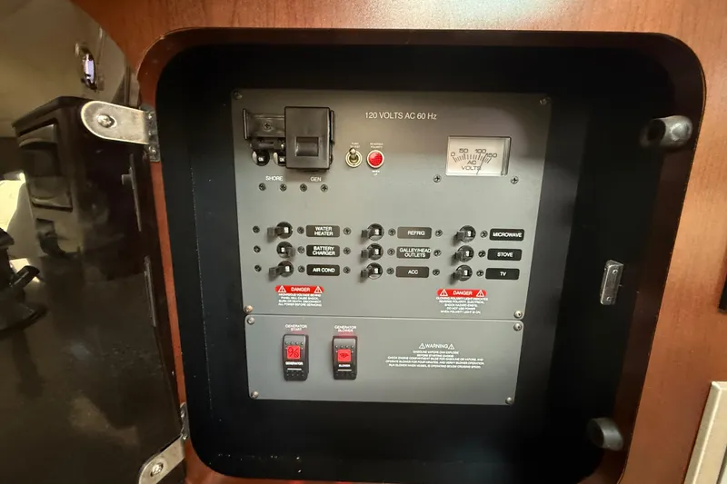 Slide: The Image of Electrical panel of 2015 Robalo R305 Walkaround boat, featuring various switches and voltage meter. - 33