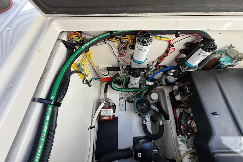 Slide: The Image of Engine compartment of a 2015 Robalo R305 Walkaround boat, showcasing wiring and components. - 35