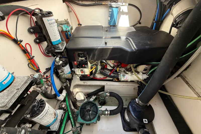 Slide: The Image of Engine compartment of a 2015 Robalo R305 Walkaround boat, showcasing wiring and components. - 36