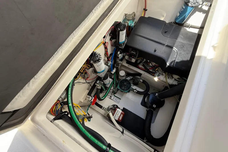 Slide: The Image of 2015 Robalo R305 Walkaround engine compartment with wiring and components visible. - 37