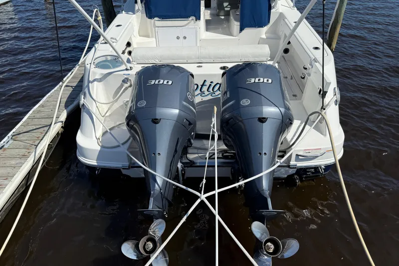 Slide: The Image of 2015 Robalo R305 Walkaround with twin Yamaha 300 engines docked at marina. - 5