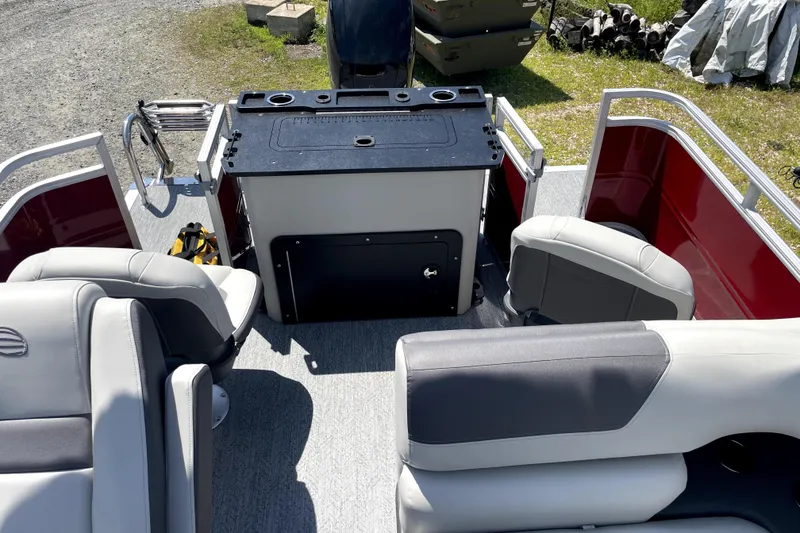 Slide: The Image of 2026 Sun Tracker Fishin' Barge 22 DLX interior with seating and fishing station. - 16