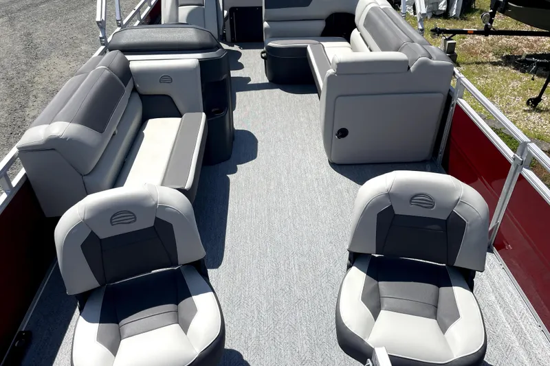 Slide: The Image of 2026 Sun Tracker Fishin' Barge 22 DLX interior with gray seating and spacious layout. - 21