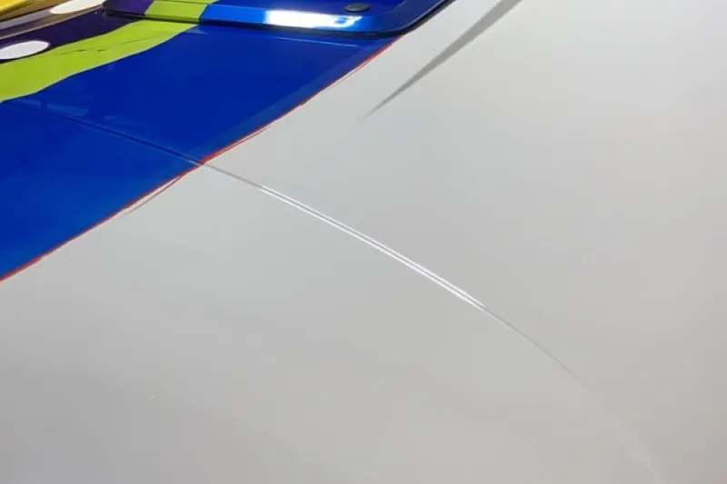 Slide: The Image of Close-up of 1999 Outerlimits 37 Stiletto boat with vibrant blue and green design. - 10