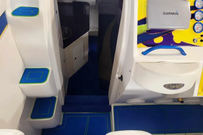 Slide: The Image of Interior of 1999 Outerlimits 37 Stiletto boat with vibrant blue and yellow accents. - 15