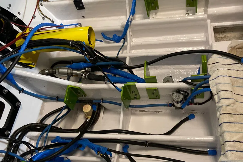 Slide: The Image of Engine compartment of a 1999 Outerlimits 37 Stiletto with visible wiring and components. - 22