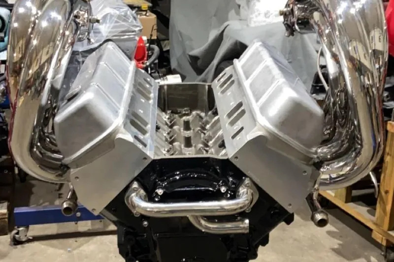 Slide: The Image of 1999 Outerlimits 37 Stiletto engine with polished components in a workshop setting. - 23