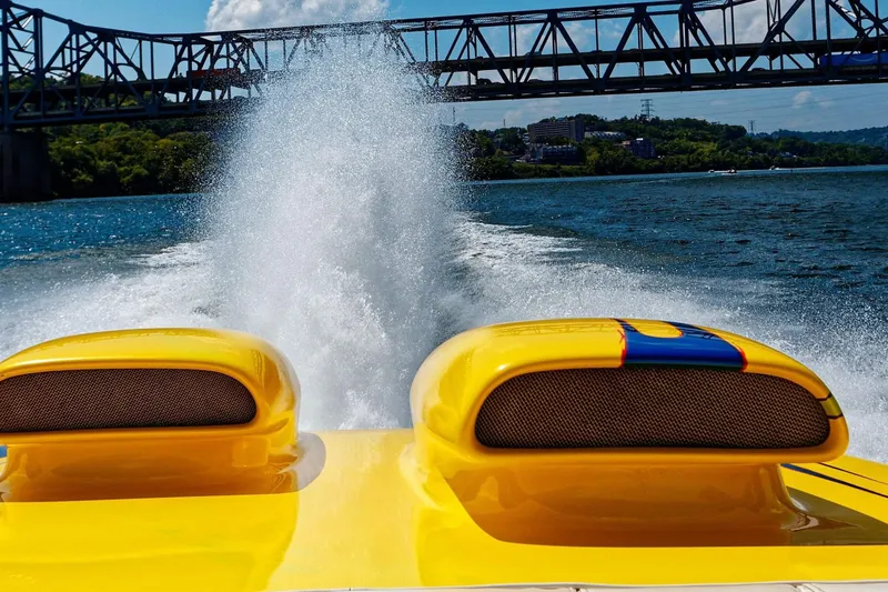Slide: The Image of Yellow 1999 Outerlimits 37 Stiletto speedboat on water, bridge in background. - 3