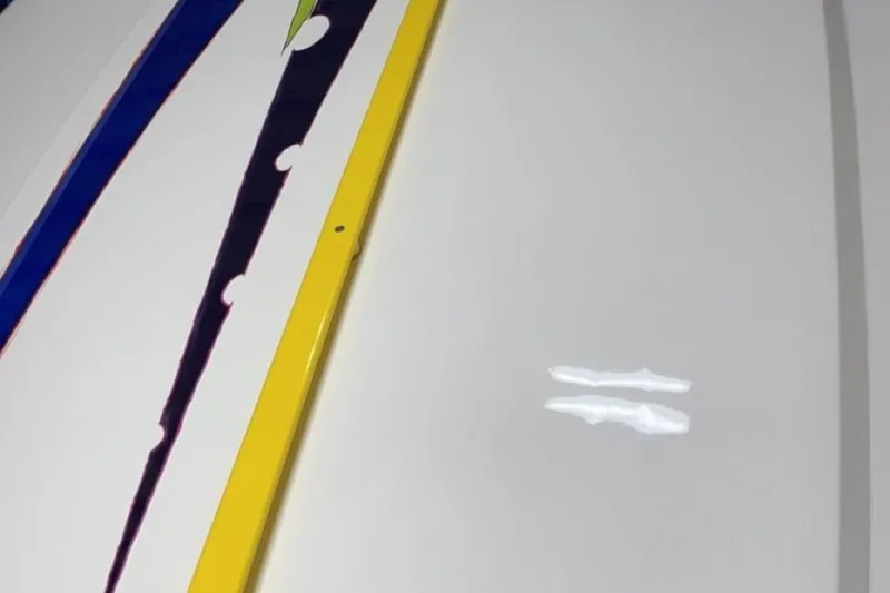 Slide: The Image of Close-up of 1999 Outerlimits 37 Stiletto boat with colorful stripes and glossy finish. - 9