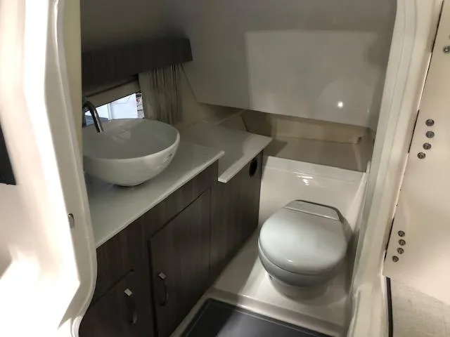 Slide: The Image of 2020 Regal 3300 Bowrider bathroom with modern sink and toilet. - 10