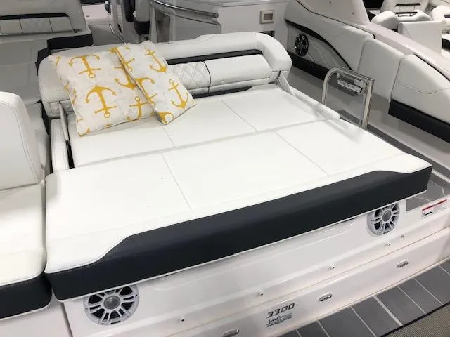 Slide: The Image of 2020 Regal 3300 Bowrider boat interior with white seating and anchor-themed pillow. - 12