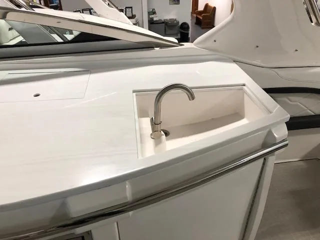 Slide: The Image of 2020 Regal 3300 Bowrider boat with a sleek onboard sink and faucet. - 15