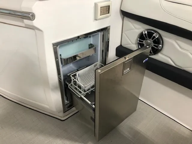 Slide: The Image of Open drawer on 2020 Regal 3300 Bowrider boat, showcasing built-in storage. - 16