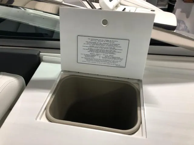 Slide: The Image of Open storage compartment on 2020 Regal 3300 Bowrider boat. - 19