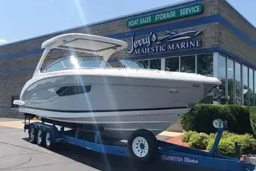 Slide: The Image of 2020 Regal 3300 Bowrider boat on trailer at Jerry's Majestic Marine dealership. - 2