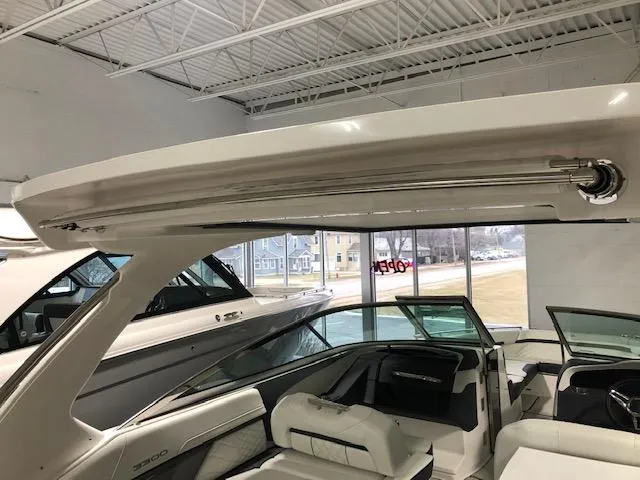 Slide: The Image of 2020 Regal 3300 Bowrider boat interior with open sunroof in showroom. - 21