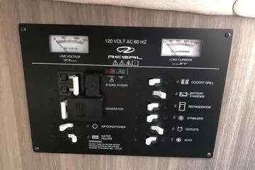 Slide: The Image of Control panel of 2020 Regal 3300 Bowrider boat, showing electrical switches and meters. - 23