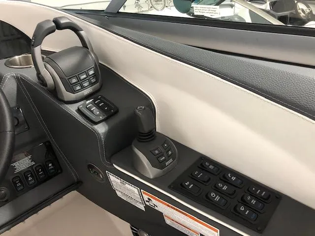 Slide: The Image of Control panel of a 2020 Regal 3300 Bowrider boat with joystick and switches. - 7