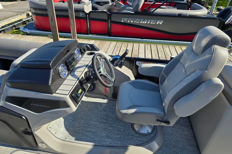 Slide: The Image of 2025 Premier 210 Sunsation RF boat interior with steering wheel and dashboard. - 10
