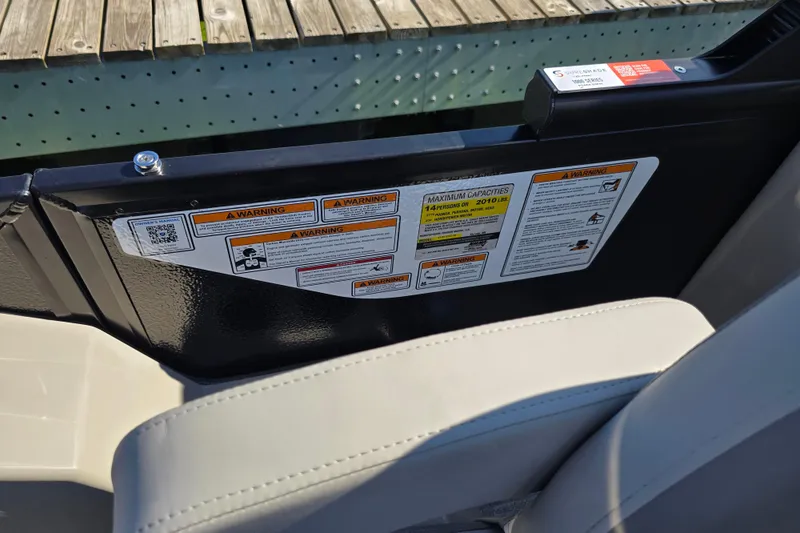 Slide: The Image of 2025 Premier 210 Sunsation RF boat warning labels and capacity information. - 11