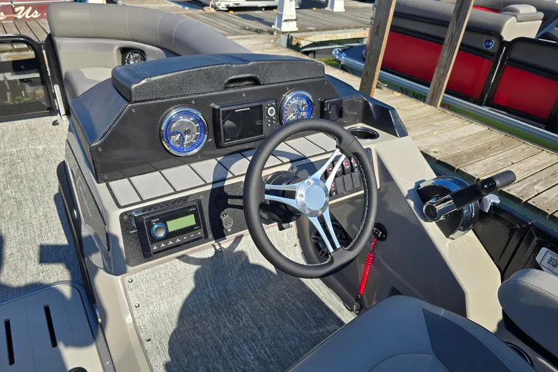 Slide: The Image of 2025 Premier 210 Sunsation RF boat dashboard with steering wheel and control panel. - 12