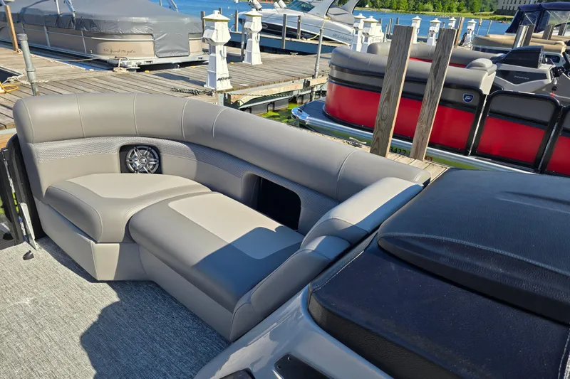 Slide: The Image of Luxurious seating on 2025 Premier 210 Sunsation RF pontoon boat at dock. - 14