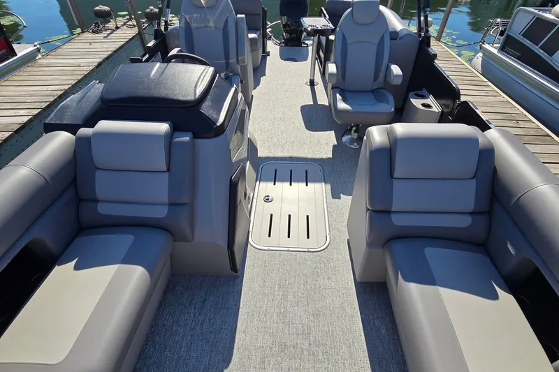 Slide: The Image of 2025 Premier 210 Sunsation RF pontoon boat interior with gray seating and modern design. - 15