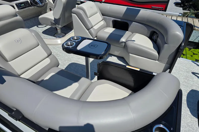 Slide: The Image of Luxurious seating on 2025 Premier 210 Sunsation RF pontoon boat with cup holders and table. - 17