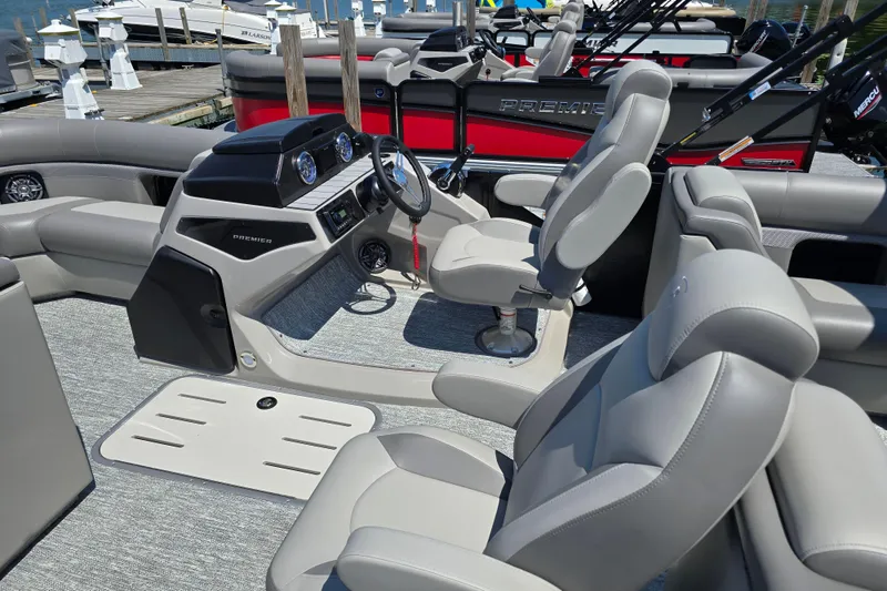Slide: The Image of 2025 Premier 210 Sunsation RF boat interior with plush seating and modern dashboard. - 18