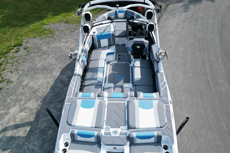 Slide: The Image of 2024 Malibu Wakesetter 23 LSV boat interior with gray and blue seating, aerial view. - 7