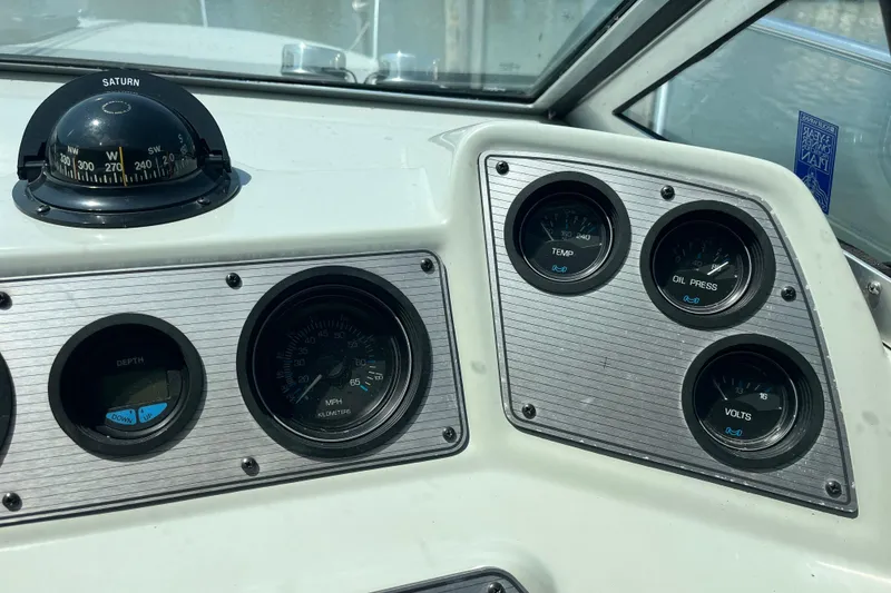 Slide: The Image of Dashboard of 1988 Four Winns 235 Sundowner boat with compass and gauges. - 11