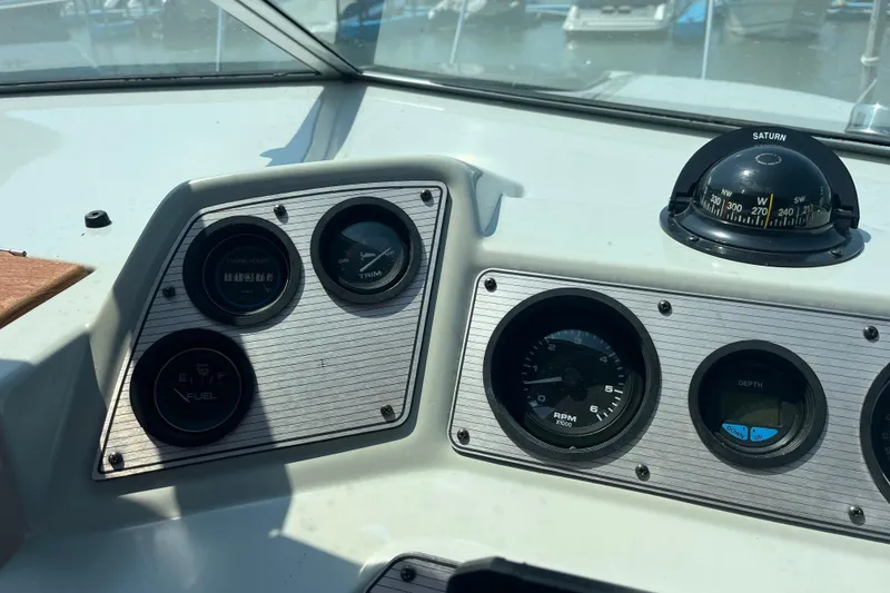 Slide: The Image of Dashboard of 1988 Four Winns 235 Sundowner boat with gauges and compass. - 12