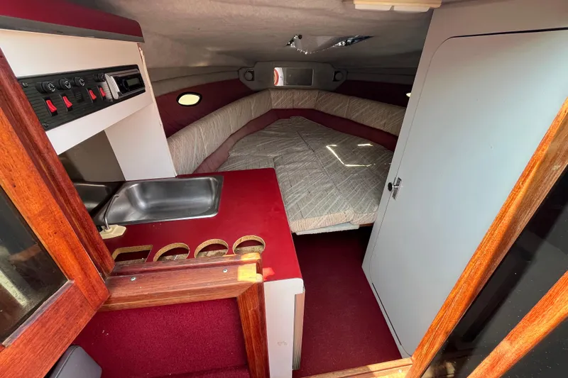 Slide: The Image of Interior of 1988 Four Winns 235 Sundowner boat with kitchenette and sleeping area. - 14