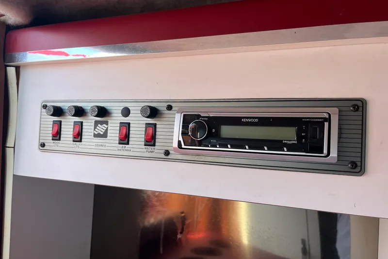 Slide: The Image of Control panel and Kenwood stereo in 1988 Four Winns 235 Sundowner boat. - 16