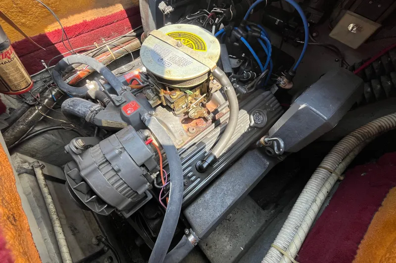 Slide: The Image of Engine compartment of a 1988 Four Winns 235 Sundowner boat, showing detailed mechanical components. - 17