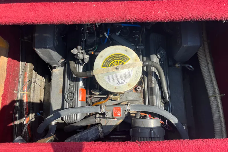 Slide: The Image of Engine compartment of a 1988 Four Winns 235 Sundowner boat, featuring detailed components. - 18