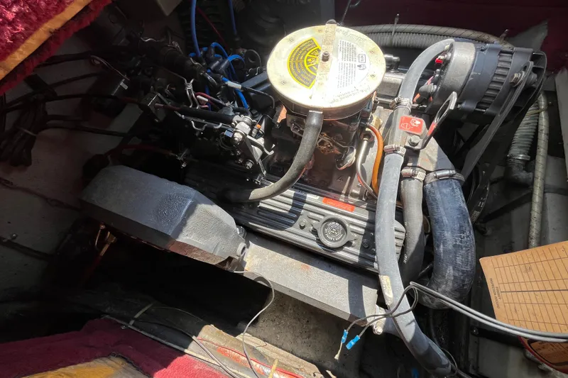 Slide: The Image of Engine compartment of a 1988 Four Winns 235 Sundowner boat, showing detailed components. - 19