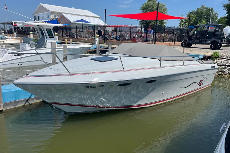 Slide: The Image of 1988 Four Winns 235 Sundowner boat docked at marina, sunny day, red accents. - 20