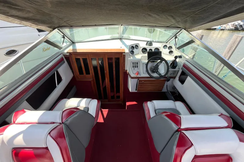 Slide: The Image of Interior of a 1988 Four Winns 235 Sundowner boat with red and white seating. - 5