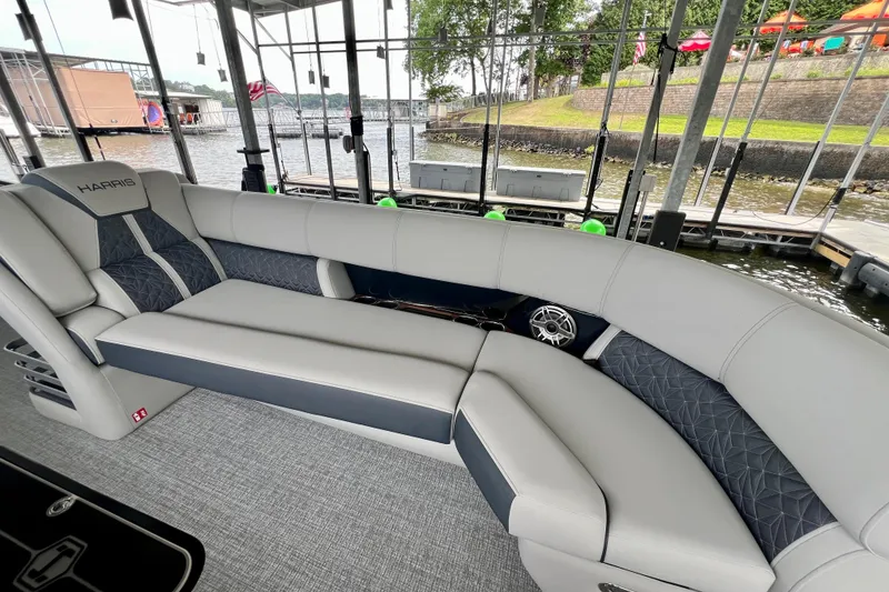 Slide: The Image of 2025 Harris Grand Mariner 250 pontoon boat interior with luxurious seating and waterfront view. - 11