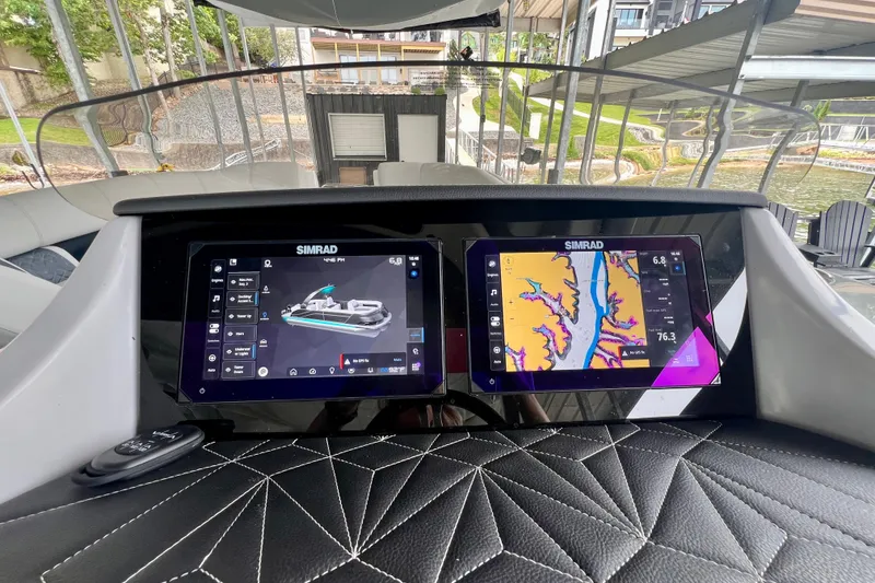 Slide: The Image of 2025 Harris Grand Mariner 250 dashboard with dual Simrad displays, showcasing navigation and control features. - 16
