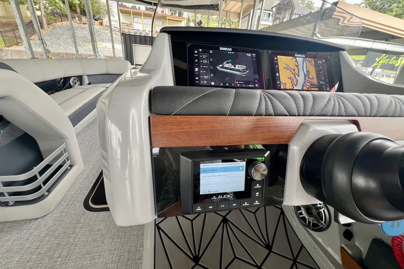 Slide: The Image of 2025 Harris Grand Mariner 250 dashboard with navigation screens and audio controls. - 17