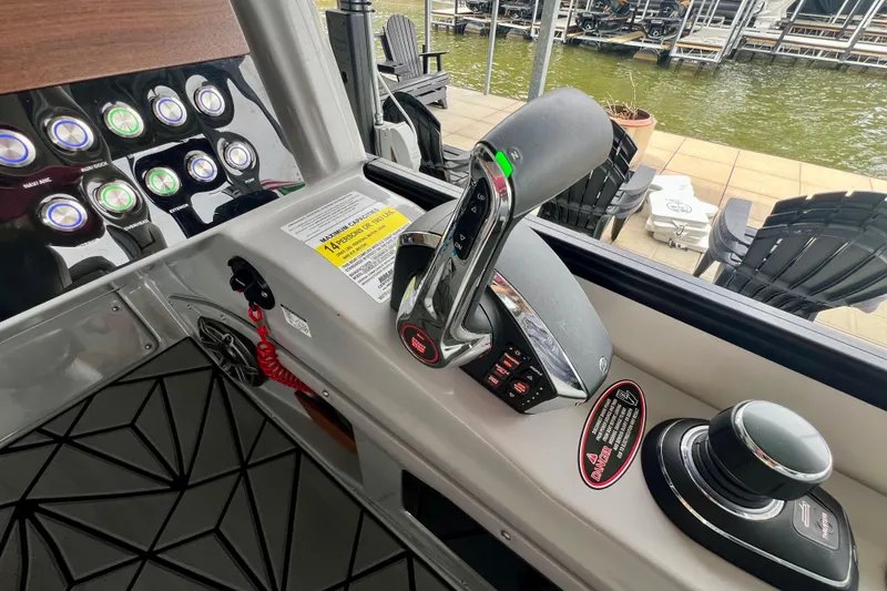 Slide: The Image of Control panel of 2025 Harris Grand Mariner 250 boat with throttle and joystick. - 19