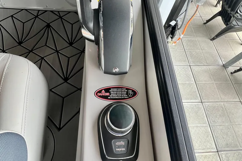 Slide: The Image of Control panel of 2025 Harris Grand Mariner 250 boat with warning label and joystick. - 21
