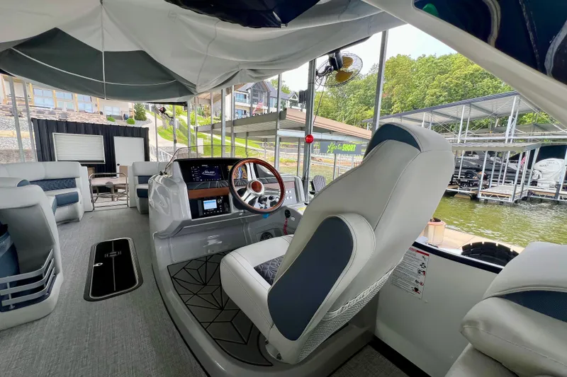Slide: The Image of Interior of 2025 Harris Grand Mariner 250 pontoon boat, featuring modern helm and seating. - 24