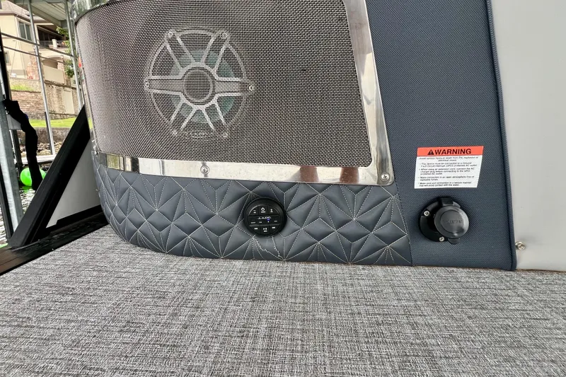 Slide: The Image of 2025 Harris Grand Mariner 250 boat interior with speaker and warning label. - 29