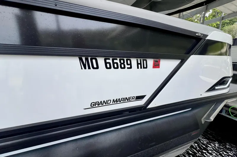 Slide: The Image of 2025 Harris Grand Mariner 250 boat with registration MO 6689 HD, docked. - 32