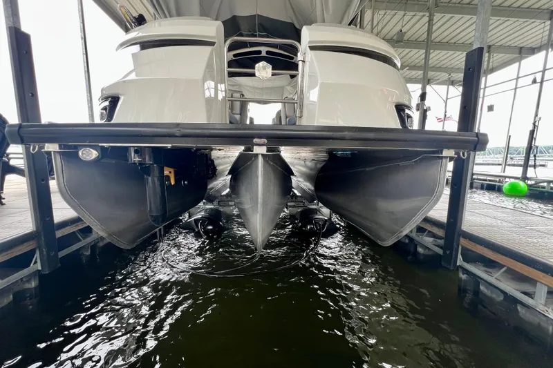 Slide: The Image of 2025 Harris Grand Mariner 250 pontoon boat docked in a marina. - 36