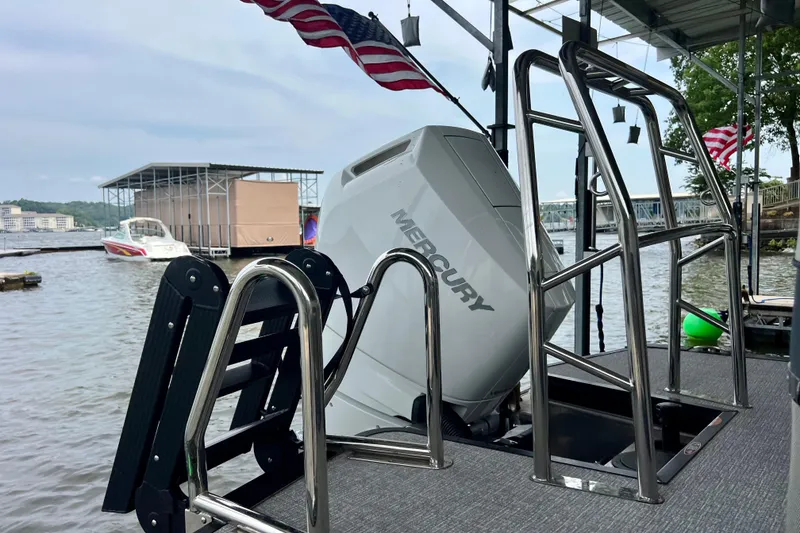 Slide: The Image of 2025 Harris Grand Mariner 250 with Mercury engine docked by the lake. - 6